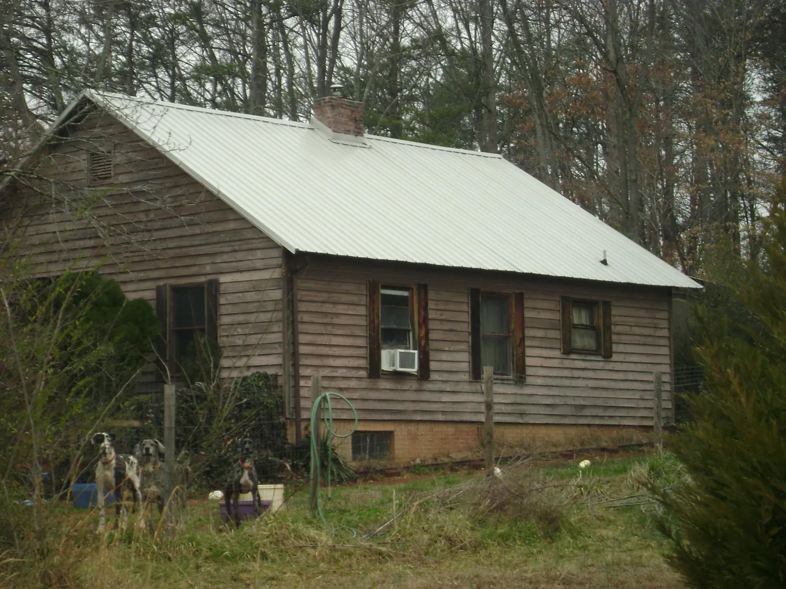 White metal roof on an old wood sided farmhouse, from a Metal Roof Installation job in New Liberty